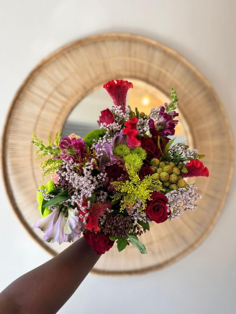 Hand-held bouquet with celosia, roses and chrysanthemums