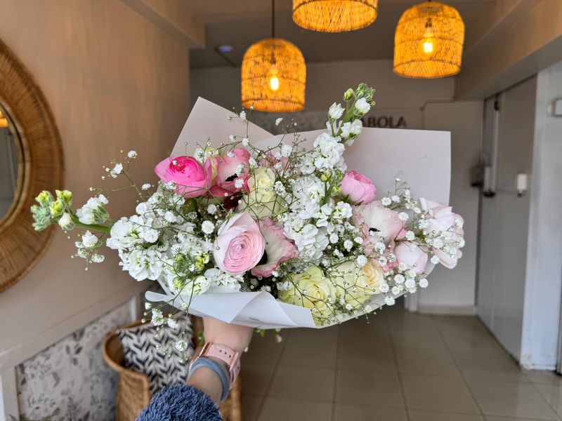 Pastel ranunculus and baby's breath bouquet in soft pink and white